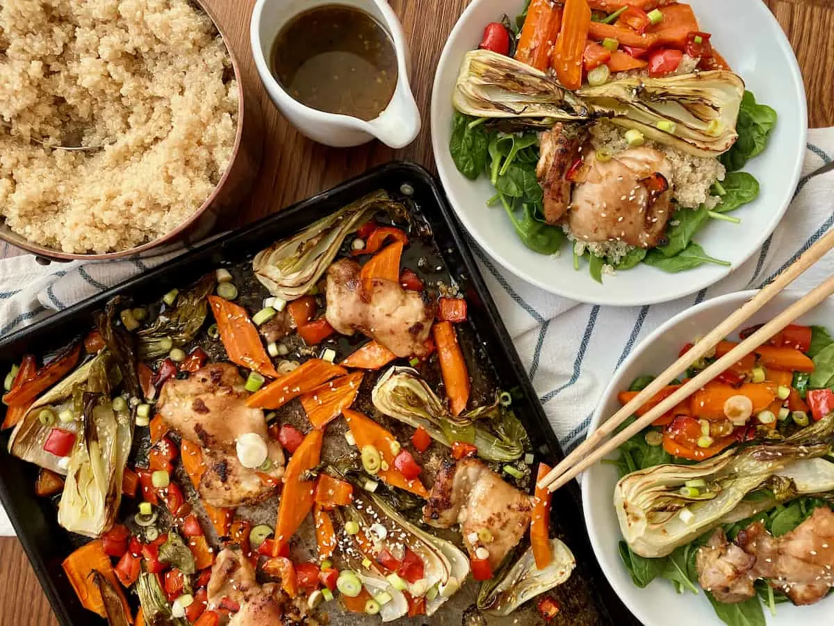 paleo sesame ginger chicken and vegetables sheet pan meal served with quinoa