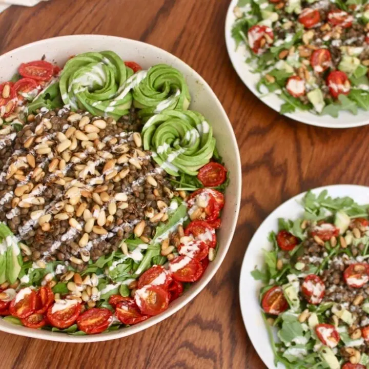 vegan arugula lentil salad with cumin toasted pine nuts oven-roasted tomatoes and avocado