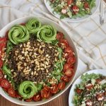 vegan arugula lentil salad with cumin toasted pine nuts, oven roasted tomatoes, and avocados