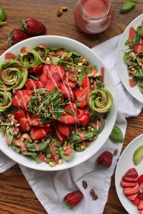 healthy strawberry avocado salad with pistachios and basil 