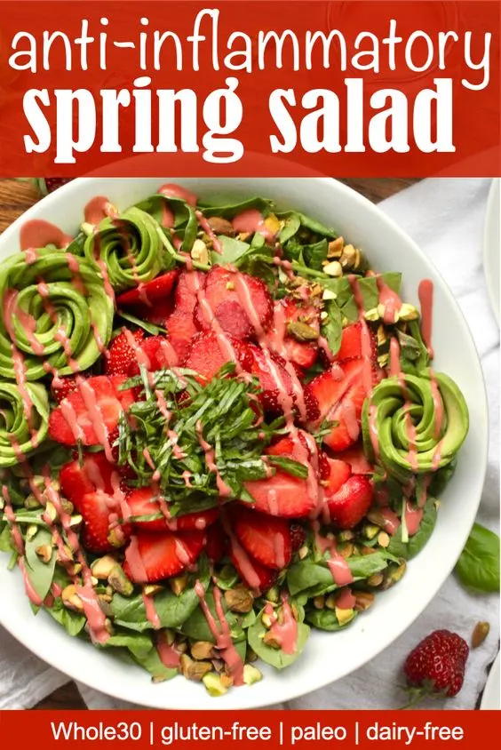 Anti-inflammatory salad with strawberries, basil, spinach, avocado, and pistachios