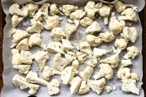 Cauliflower florets on baking sheet ready to roast