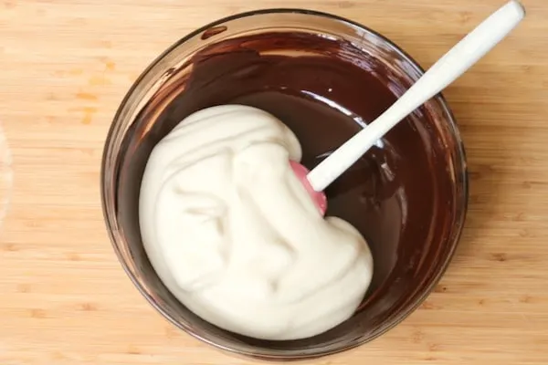 Fold half of whipped eggs into chocolate mixture