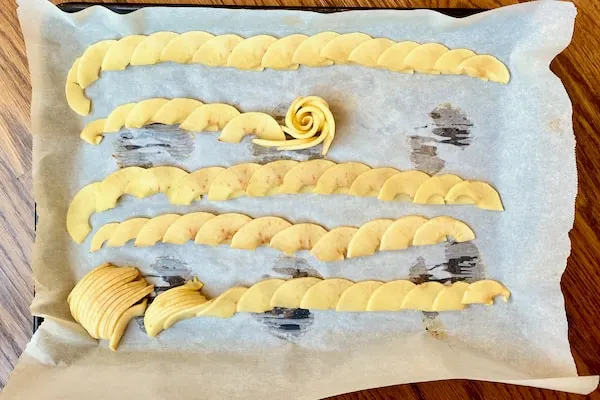 arrange apple slices into strips and start rolling into an apple rose