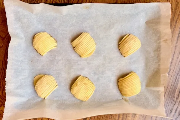 baked apple slices on parchment lined baking sheet