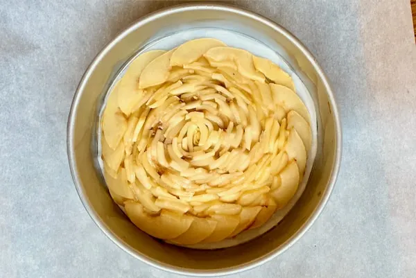 inverted apple flower on bottom of prepared cake pan