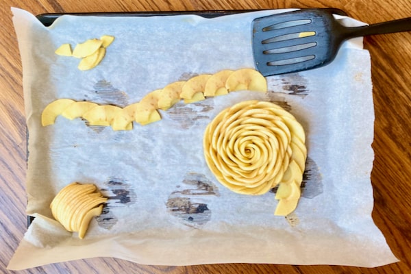 shape baked apple slices into a flower. use a spatula to help you move the flower